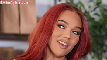 A transgender beauty with red hair gives oral pleasure before having sex in a cafe with a couple